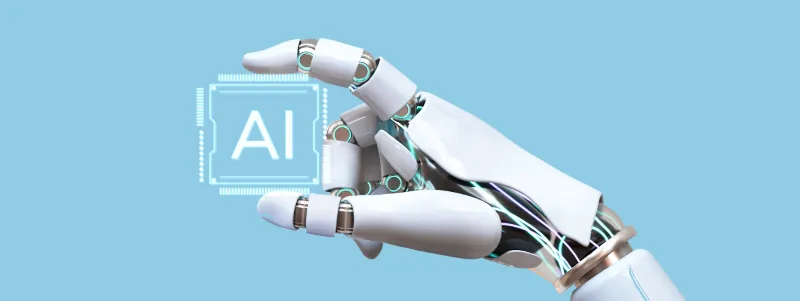 Robot hand holding the phrase AI in its fingers